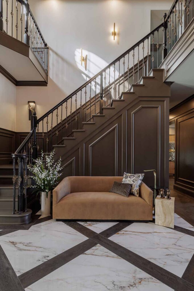 Foyer detail of sofa against a dark wall and staircase