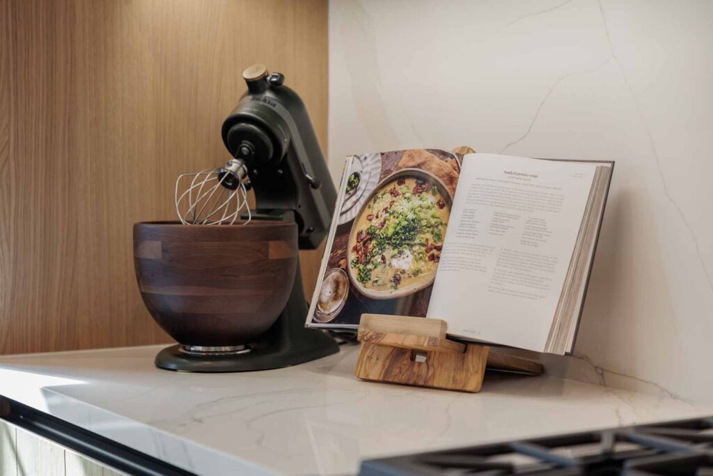 Kitchen detail of Kitchenaid mixer with nearby cookbook propped up