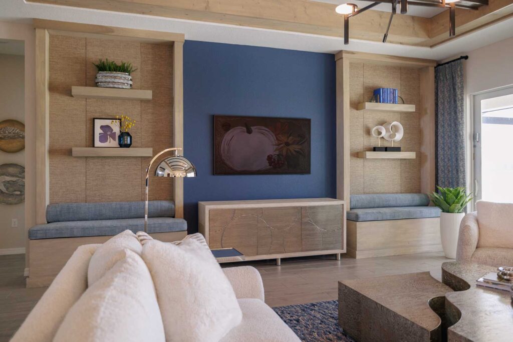 Living room detail of built-in TV wall featuring blue wall and wooden shelves